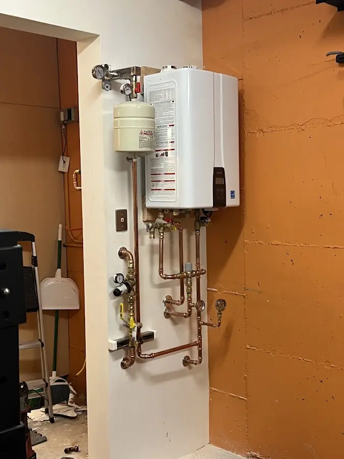 Plumbing technician inspecting water heater connections in Yulee